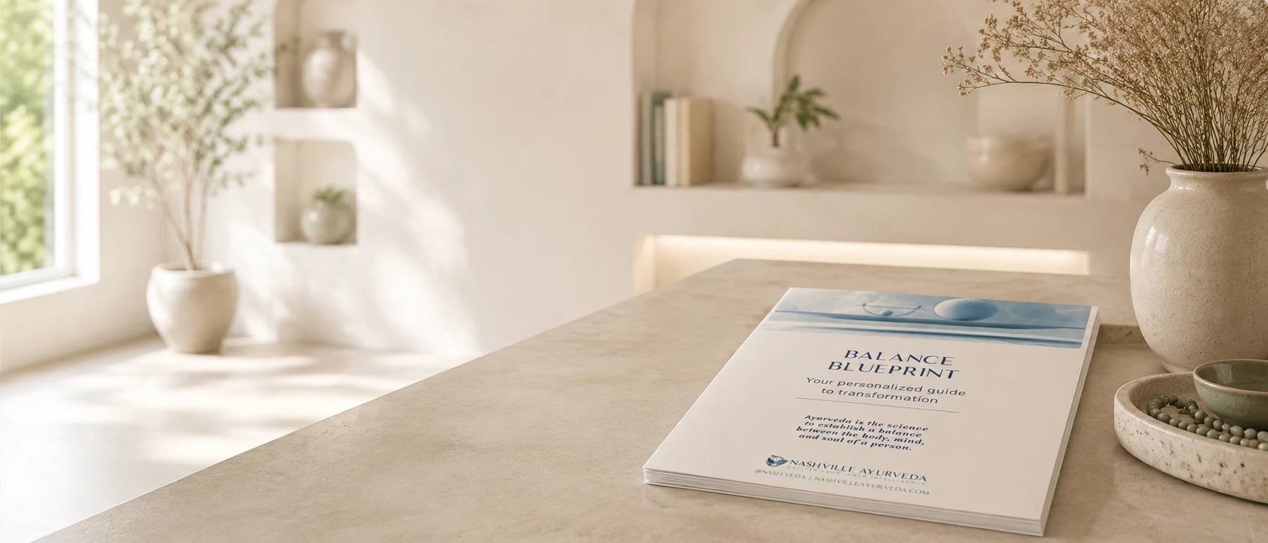 The Balance Blueprint guide resting on a stone counter in a serene, sunlit studio